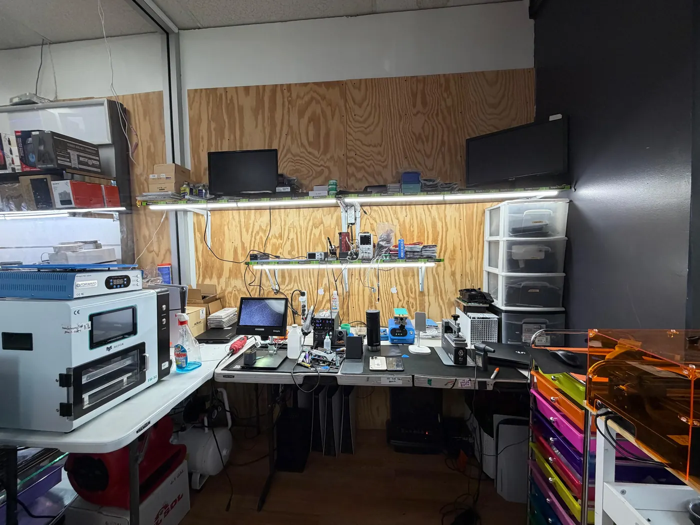 The Phone King Unlocks repair bench in Harvey, IL, with a microscope, soldering station and screen tools